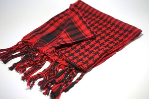 Detail of red and black checkered keffiyeh desert scarf with decorative fringe tassels
