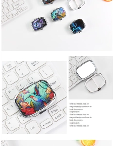 Compact metal pill box with hummingbird design, internal mirror, and two compartments