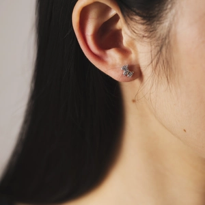 Minimalist S925 silver puppy stud earrings with sparkling diamonds on female model