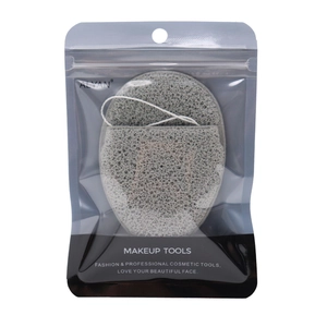 Detailed view of grey porous makeup sponge with hanging rope in transparent bag