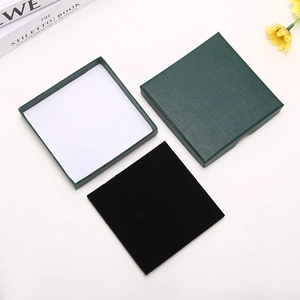Deep green square jewelry gift box with linen texture and black velvet interior lining