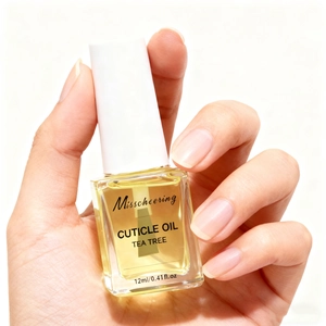 Macro shot of 12ml tea tree cuticle oil bottle showing transparent glass and applicator