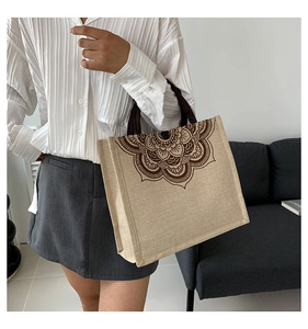 Linen tote bag with mandala print shown on model to display size and boho style