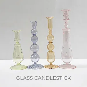 Artistic borosilicate glass candle holders in various colors for creative table decor