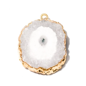 Close-up of a natural agate slice pendant with gold-plated edges and blue crystal core