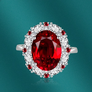 Macro detail of oval ruby gemstone ring with double-layered halo diamond setting