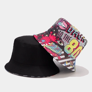 Retro 80s style reversible bucket hat in solid black and colorful vintage print
