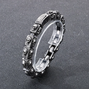 Macro shot of retro stainless steel square links with skull relief on a man's bracelet