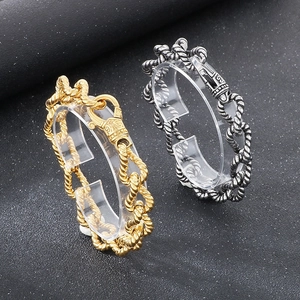 Detailed view of vintage twisted rope chain bracelets in silver and gold finishes