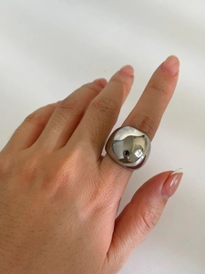 Macro view of wide silver titanium ring with polished mirror finish on model's hand