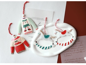 Detail of vintage metal Christmas tree ornaments featuring car and rocking horse shapes