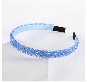 Detailed close-up of light blue multi-layer crystal headband with satin lining