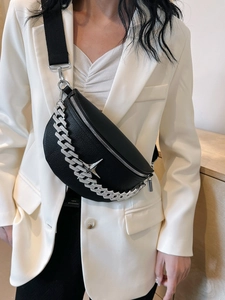 Detail of black pebbled leather crescent bag with silver chunky chain and star buckle