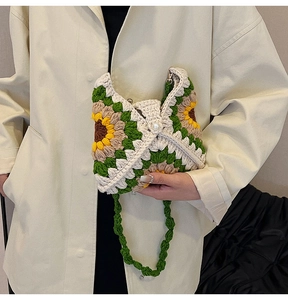 Close-up of handmade crochet sunflower bag with large pearl button and knit texture