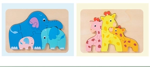 Detail of wooden 3D animal puzzles featuring elephant and giraffe family designs