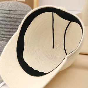Detailed macro view of cream woven baseball cap interior with black sweatband and stitching