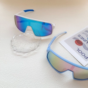 Detail of kids cycling sunglasses with white blue and light blue frames on a white surface