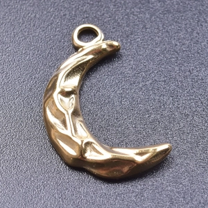 Detailed macro shot of 18k gold-plated crescent moon pendant with hammered texture finish