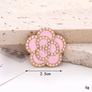 Detail of pink enamel camellia shoe charm with white pearls and 2.5cm size mark