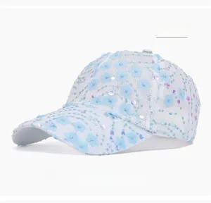 Detail of light blue floral lace embroidery and sequins on breathable mesh baseball cap