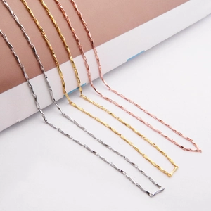 Detail of s925 silver, gold, and rose gold wave twist chains showing metallic luster