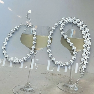 Macro detail of S925 sterling silver beads necklace with heart pendant and lobster clasp