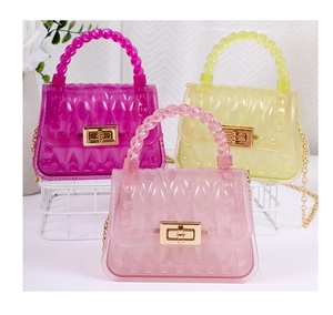 Detailed view of PVC jelly bags in pink, yellow and purple with embossed leaf patterns