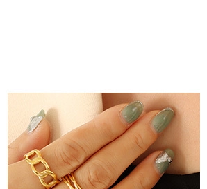 Close-up of golden multi-layer chain ring design worn on finger for fashion look