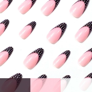 Long almond press-on nails with soft pink base and black French polka dot tips