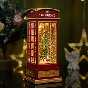Vintage red Christmas telephone booth music box with glowing tree and snowman inside