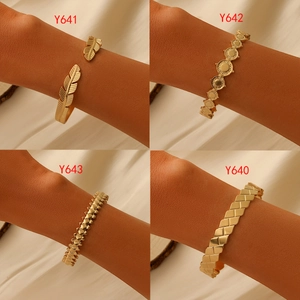 Detailed close-up of four gold stainless steel bracelets with unique texture designs