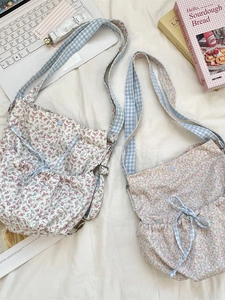 Chic floral canvas crossbody bag with drawstring closure and adjustable plaid straps