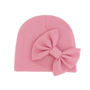 Pink newborn baby hat with large bow decoration made of warm double-layer knit fabric