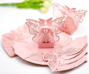 Pink laser-cut butterfly favor box detail with silk ribbon and flat-pack assembly view