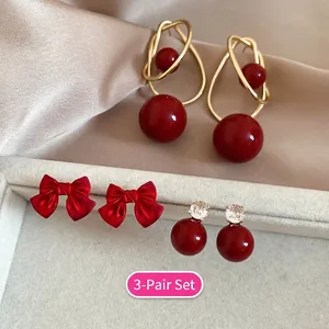 3-pair set of red heart pearl earrings with gold accents and elegant ribbon designs
