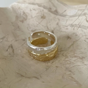 Detailed close-up showing S925 sterling silver stamp on hammered irregular rings