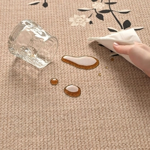 Waterproof Zen style rug with black floral patterns on beige woven texture surface
