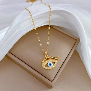 Luxury gold titanium steel evil eye necklace with crystals on white silk background