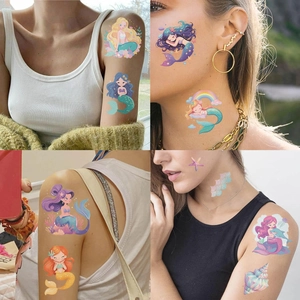 Detail showing waterproof cartoon mermaid temporary tattoos applied on arms and face