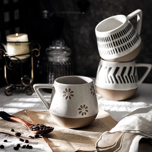Set of three Nordic ceramic mugs with floral, striped, and arrow patterns in cream tones