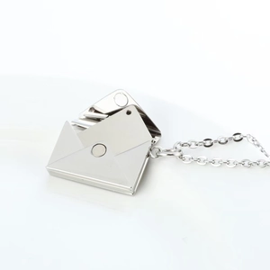 Detail of an openable envelope pendant with polished silver finish and internal metal plate