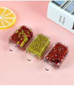 Creative ice pop pendants with realistic red and green bean fillings on pink background