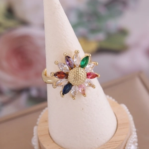 18K gold sunflower ring with colorful marquise-cut zircons on a white display stand