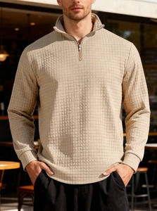 Close-up of men's waffle knit sweatshirt featuring a half-zip collar and textured fabric