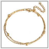 Detail of 18K gold stainless steel layered anklet showing bead chain and extender