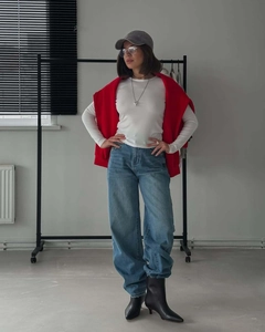 Urban leisure style outfit with white long sleeve top, blue jeans, and red knit sweater