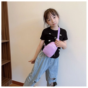 Child wearing purple mini crossbody chest bag with zipper, casual street style outfit