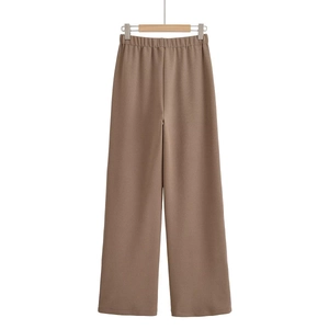Close-up of coffee brown high-waisted wide-leg knit trousers with elastic waistband