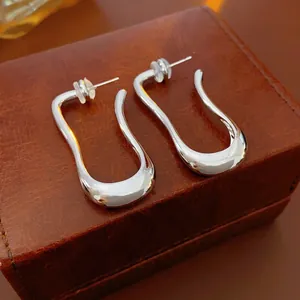 Minimalist silver irregular U-shaped fluid metal earrings with high polish finish