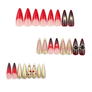 Red gradient stiletto nails with chrome crosses, sparkling rhinestones and gold stars